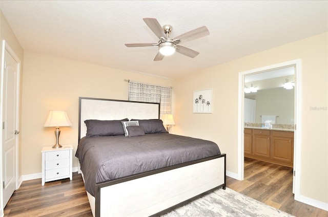 bedroom featuring connected bathroom, ceiling fan, dark hardwood / wood-style flooring, and a textured ceiling