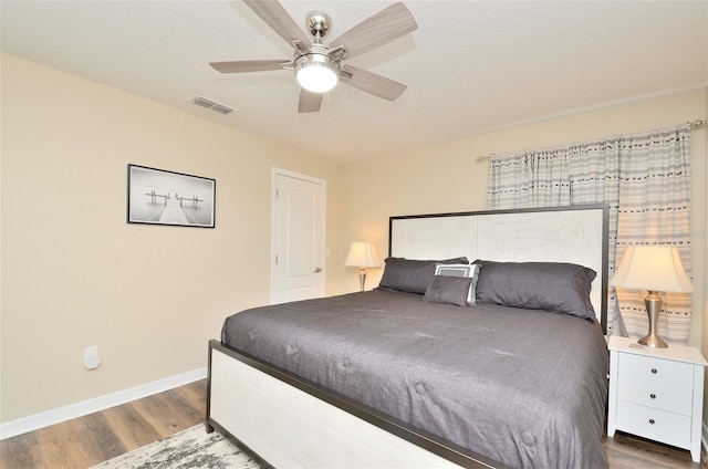 bedroom with ceiling fan and dark wood-type flooring