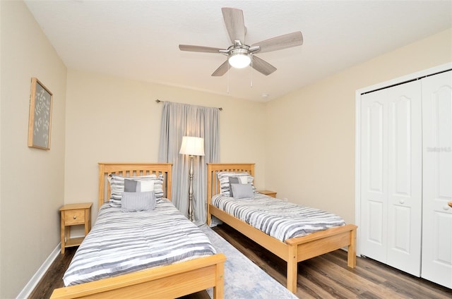 bedroom featuring ceiling fan, dark hardwood / wood-style flooring, and a closet