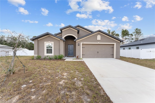 single story home with a garage and a front lawn