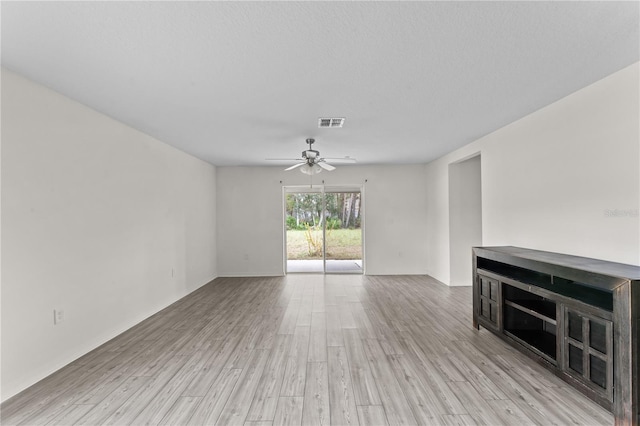 unfurnished living room featuring ceiling fan, a textured ceiling, and light wood-type flooring