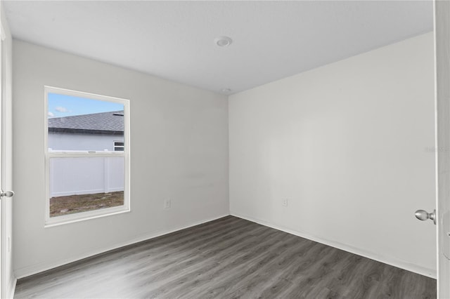 spare room with dark wood-type flooring