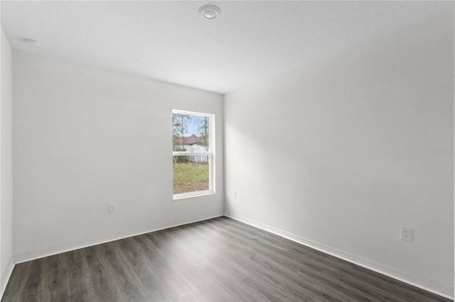 spare room featuring dark hardwood / wood-style floors