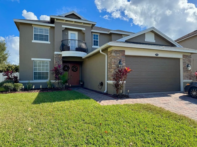 view of front of house featuring a garage, a balcony, and a front yard