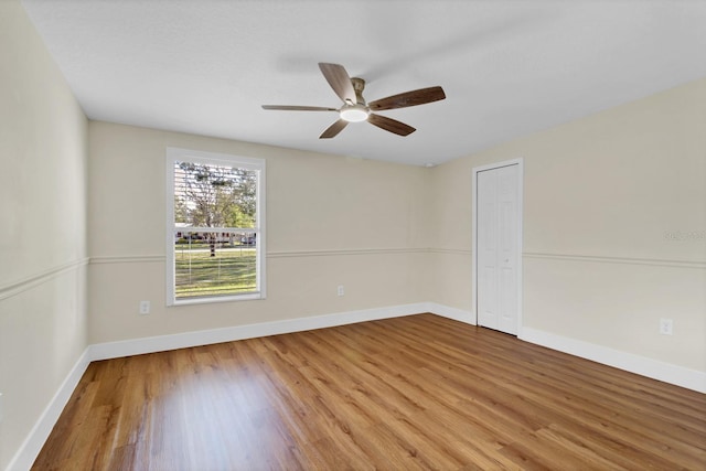 unfurnished room with hardwood / wood-style flooring and ceiling fan