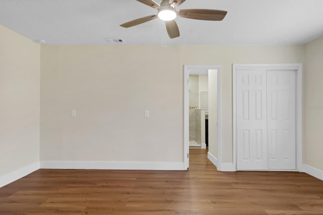 interior space with hardwood / wood-style floors, ceiling fan, and a closet