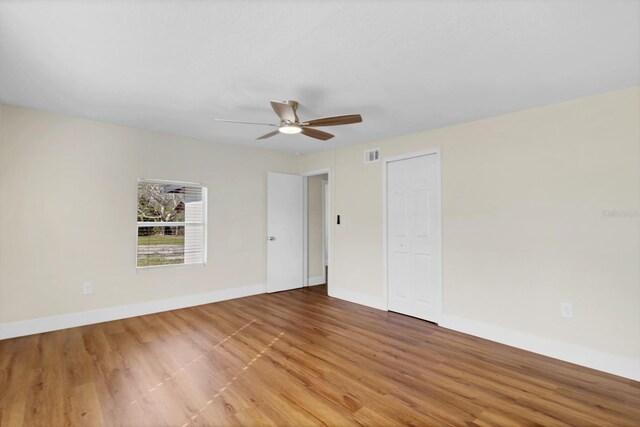 unfurnished room with ceiling fan and wood-type flooring