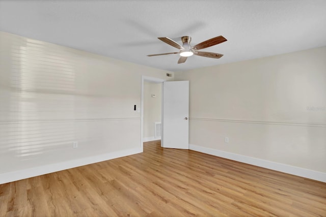 empty room with ceiling fan and light wood-type flooring