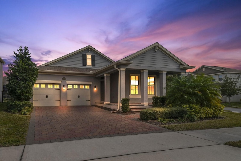 view of front of home with a porch and a garage