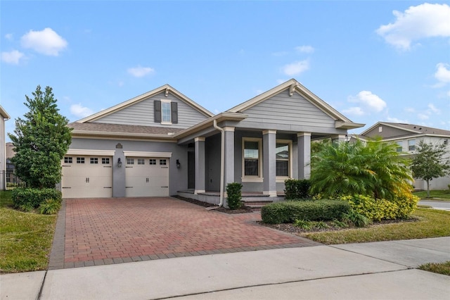 view of front of property with covered porch and a garage