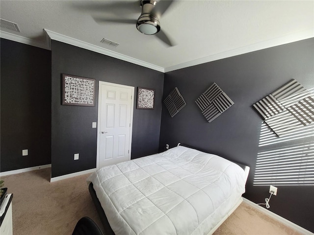 bedroom with ceiling fan, crown molding, and carpet flooring