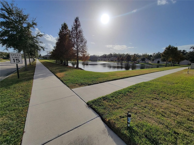 view of home's community featuring a yard and a water view