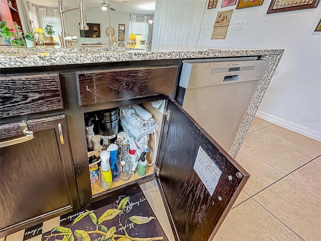 interior details with dishwasher, light stone countertops, and ceiling fan