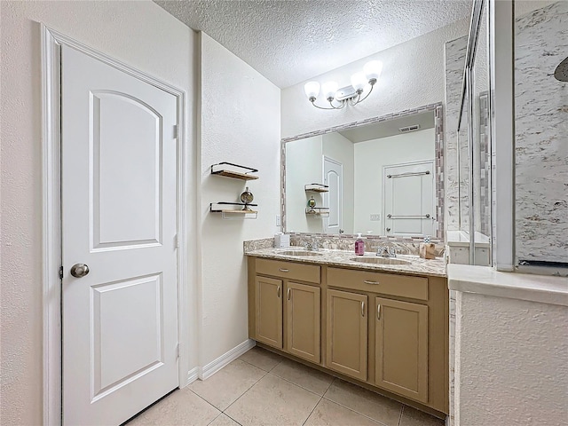 bathroom featuring vanity, a textured ceiling, a chandelier, and tile patterned floors