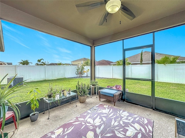 unfurnished sunroom with ceiling fan