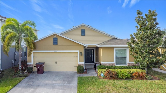 view of front of house with a front yard and a garage