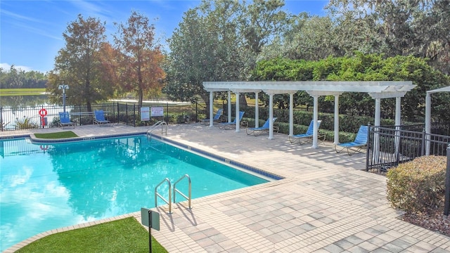 view of pool featuring a pergola, a patio area, and a water view