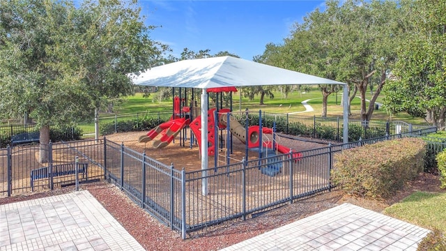 view of playground with a lawn