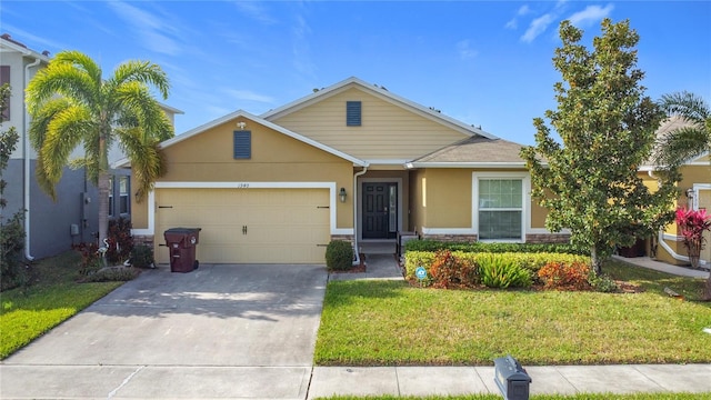 view of front of home featuring a front yard and a garage