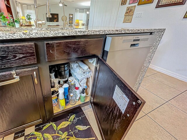 interior details featuring white dishwasher and light stone countertops