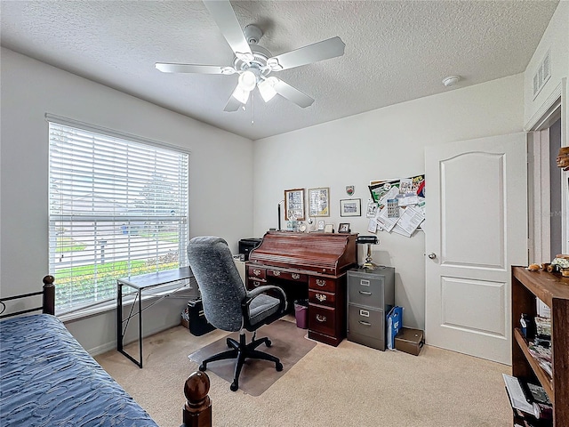 office area featuring ceiling fan, light carpet, and a textured ceiling