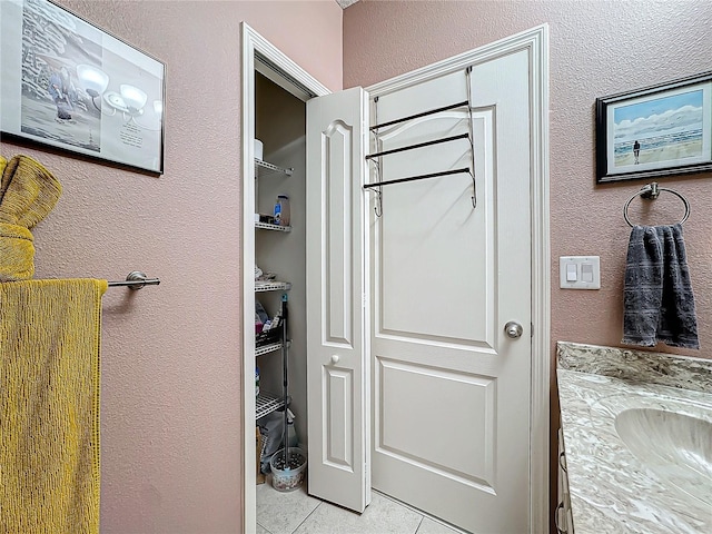 bathroom with tile patterned flooring and vanity