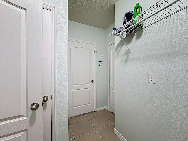 walk in closet featuring light tile patterned flooring