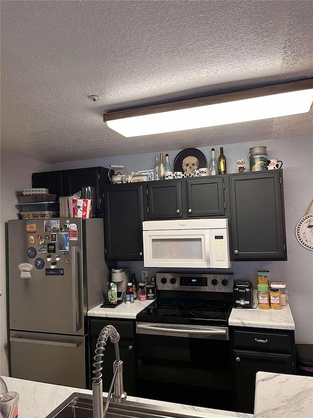 kitchen featuring a textured ceiling and stainless steel appliances