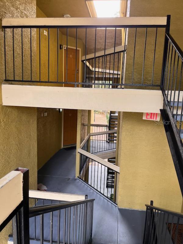 stairway featuring a towering ceiling