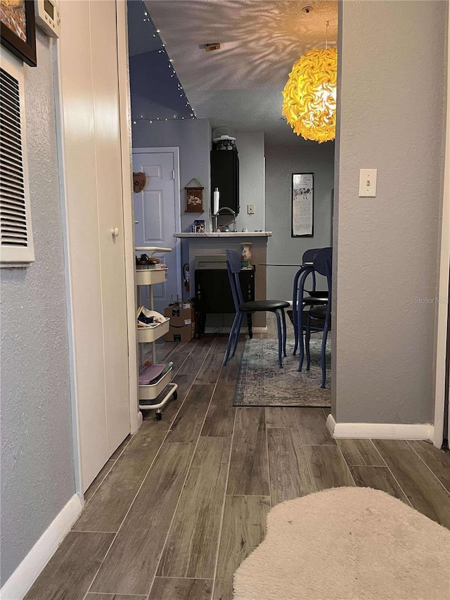 hallway with dark hardwood / wood-style flooring