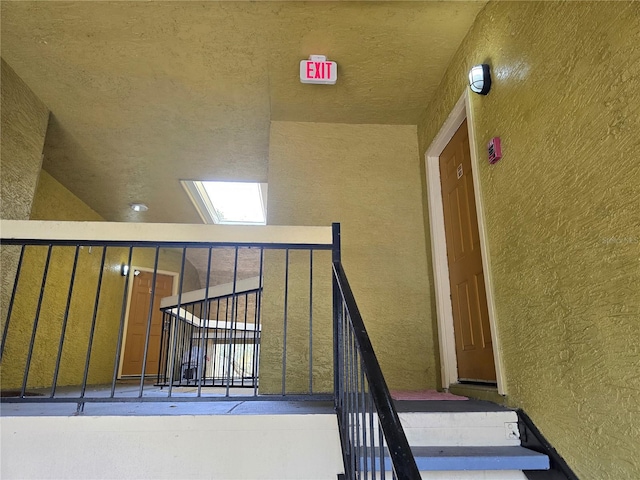 stairway featuring lofted ceiling