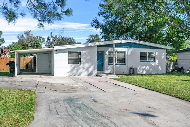 ranch-style house with a carport and a front yard