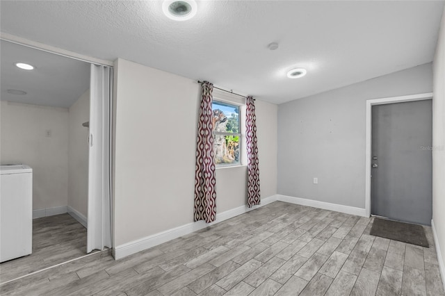 interior space with washer / dryer and a textured ceiling