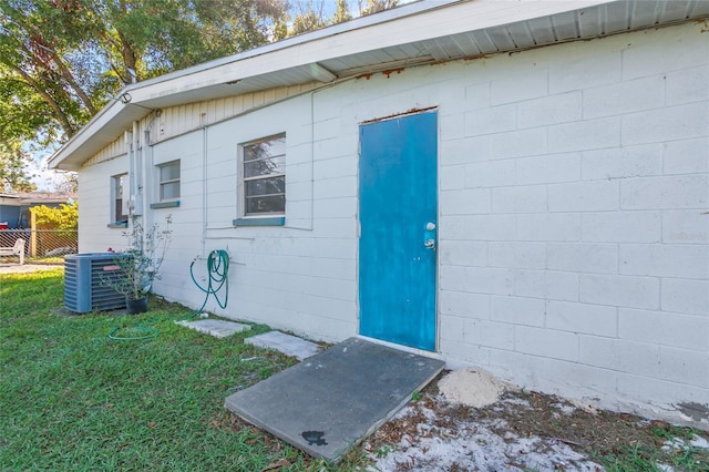 view of outbuilding with central air condition unit and a yard