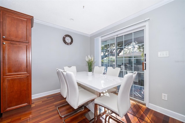 dining room featuring dark hardwood / wood-style floors and crown molding