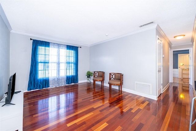 living area featuring hardwood / wood-style flooring and ornamental molding