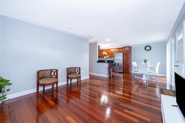 sitting room featuring dark hardwood / wood-style flooring and ornamental molding