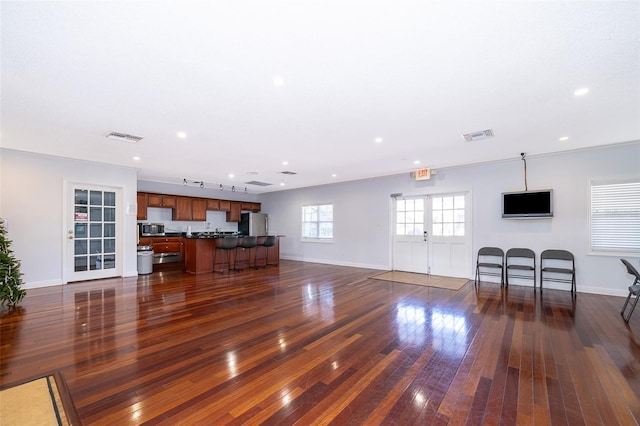 living room featuring dark hardwood / wood-style floors, crown molding, and french doors