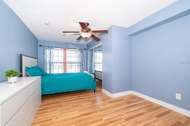 bedroom featuring ceiling fan and light hardwood / wood-style floors