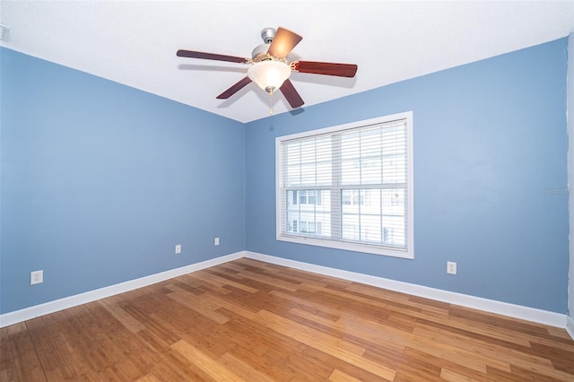 unfurnished room with hardwood / wood-style flooring and ceiling fan