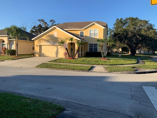 view of front of house with a garage and a front lawn