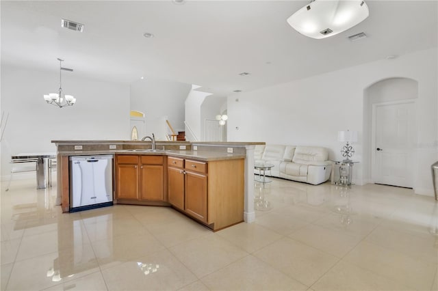 kitchen featuring dishwasher, an inviting chandelier, a center island with sink, sink, and decorative light fixtures