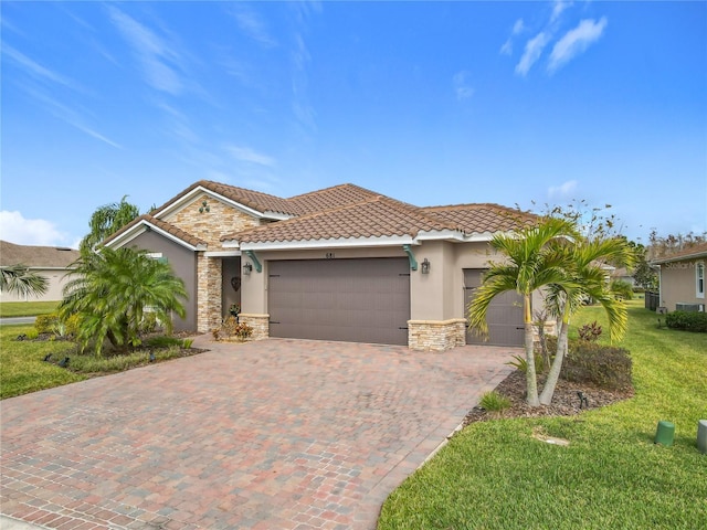 view of front of home with a garage and a front lawn