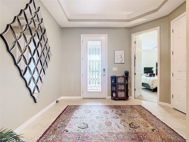 foyer entrance with a raised ceiling