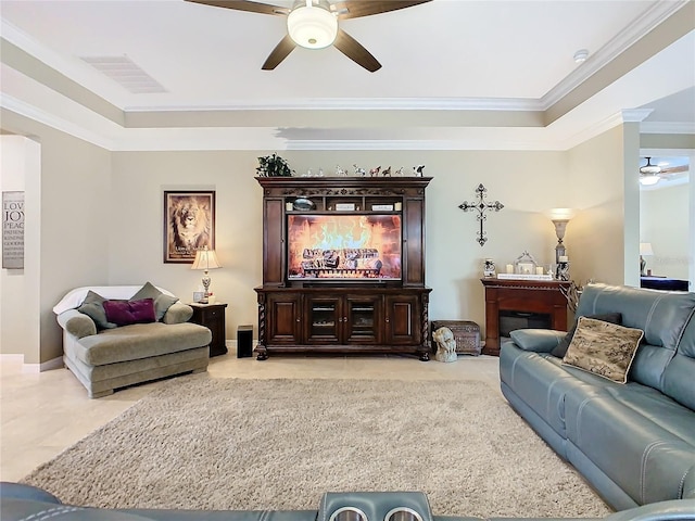 tiled living room with ceiling fan and crown molding