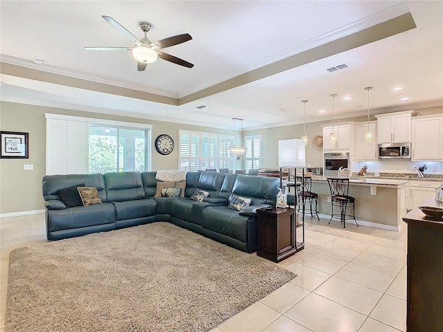 living room featuring crown molding, light tile patterned floors, a healthy amount of sunlight, and ceiling fan