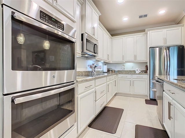 kitchen with white cabinets, stainless steel appliances, and ornamental molding