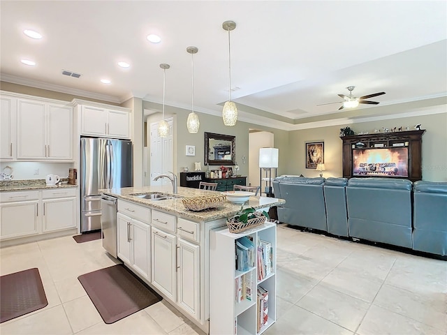 kitchen featuring white cabinetry, sink, an island with sink, and appliances with stainless steel finishes