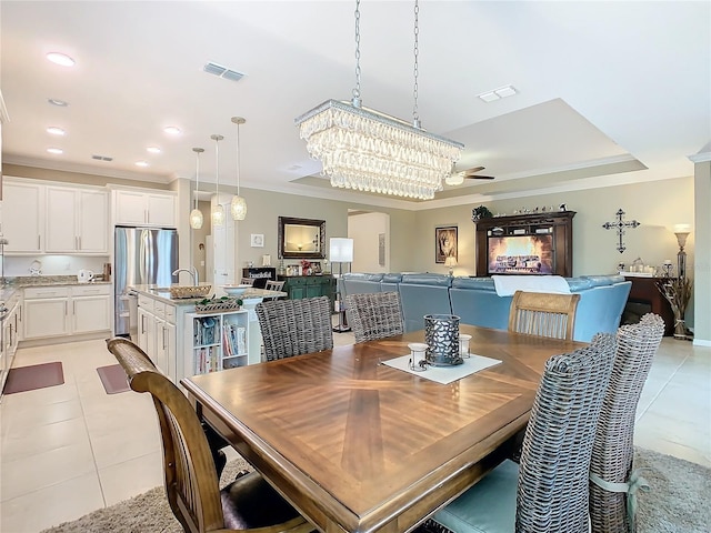 dining area with ceiling fan, sink, light tile patterned floors, and ornamental molding