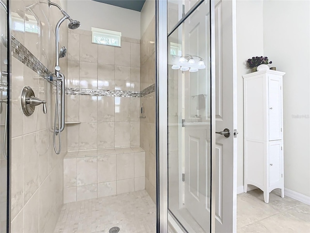 bathroom featuring a shower with shower door